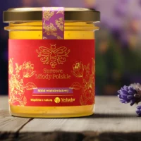 Jar of Yerbador Raw Multiflower Honey with a label on a wooden table