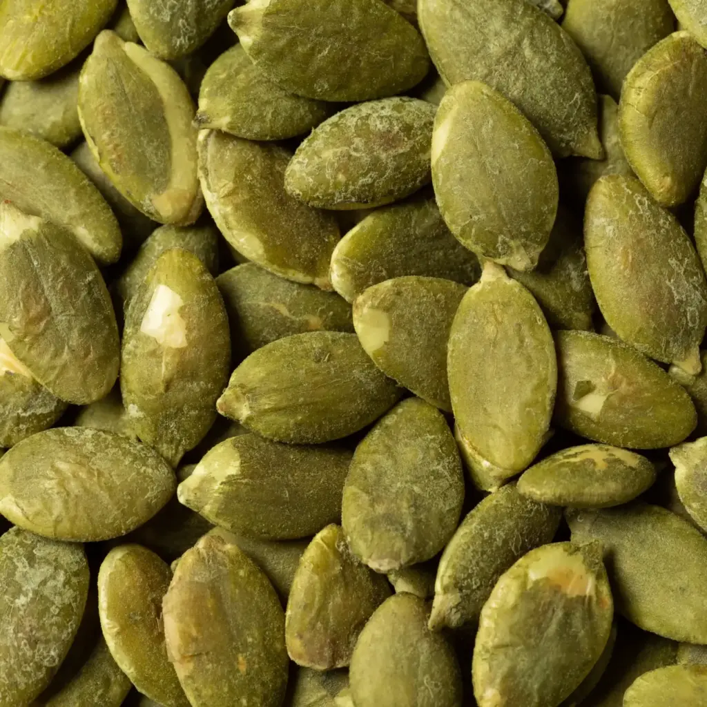 Close-up of shelled green pumpkin seeds – visible grain texture