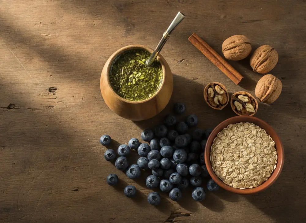 Yerba mate and insulin resistance – matero with dried leaves next to nuts, cinnamon and oat flakes