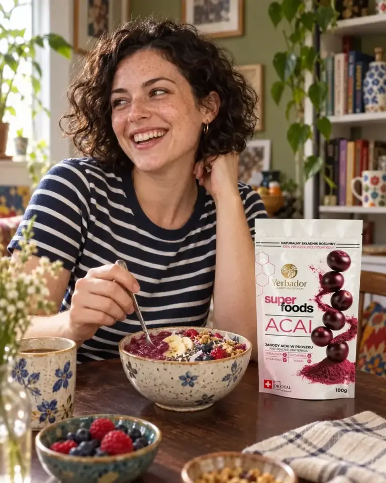 Laughing young woman at the table with an açaí bowl and Yerbador açaí package