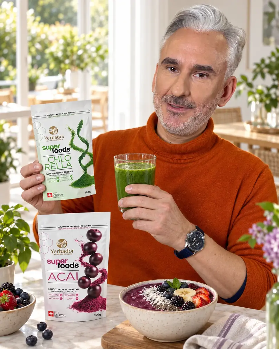 Gray-haired man in an orange sweater with a green smoothie, bowl and Yerbador superfoods