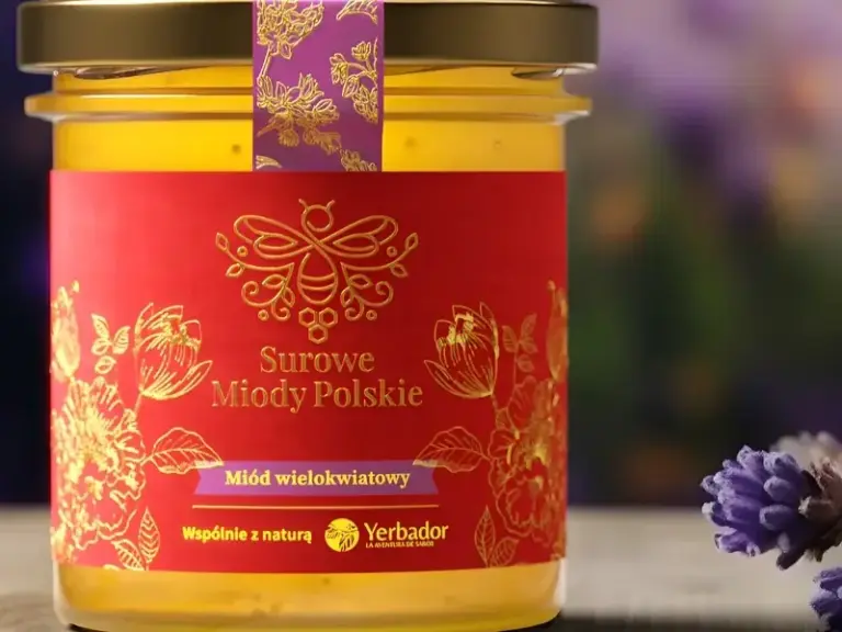 Jar of Yerbador raw multiflower honey on wood, lavender in the background