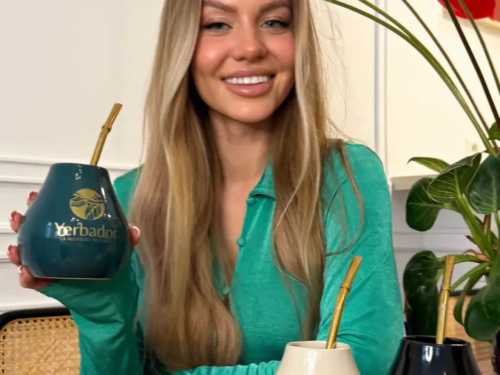 Yerba mate vessel: woman in a green sweater with a collection of Yerbador materos